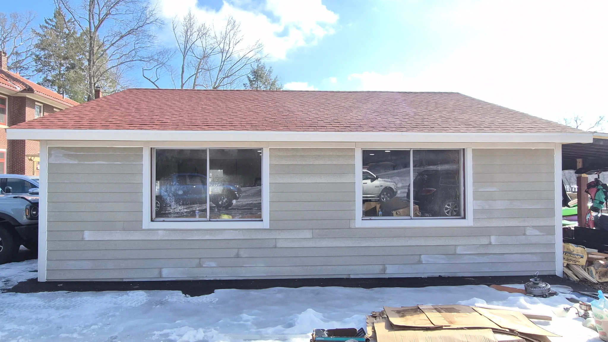 New residential addition with dimensional asphalt shingle roof and horizontal fiber cement siding